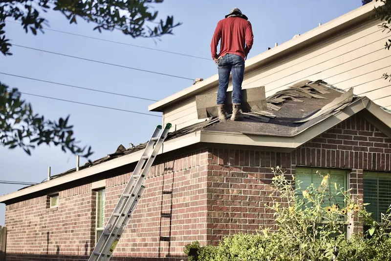 Professional roofer working on a residential roof in Government Center